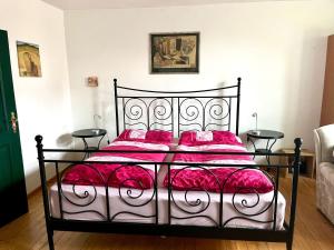 a bedroom with a black and white bed with red sheets at Apartment Spitzwegerich by Interhome in Kappe
