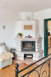 a living room with a fireplace and a couch at Apartment Spitzwegerich by Interhome in Kappe