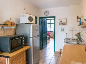 a kitchen with a refrigerator and a microwave at Apartment Spitzwegerich by Interhome in Kappe