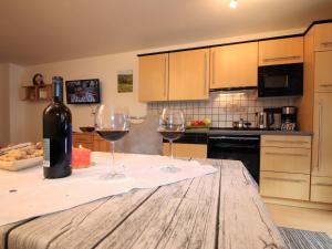 two glasses of wine sitting on a table in a kitchen at Apartment Igel by Interhome in Bad Bayersoien