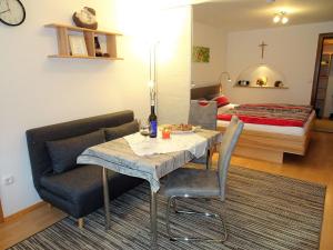 a room with a dining table and a bed at Apartment Igel by Interhome in Bad Bayersoien