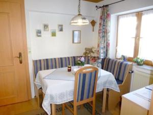 a dining room with a table and two chairs at Apartment FeWo Bärli by Interhome in Bad Bayersoien