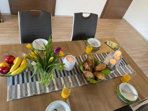 a table with a tray of food and fruit on it at Apartment Gästehaus Siebert by Interhome in Bad Brambach