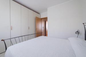 a bedroom with a bed with white sheets at Blu Garda View in Polpenazze del Garda +26 photos