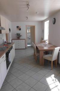a kitchen with a wooden table and a dining room at Apartment Mortelgrund by Interhome in Sayda