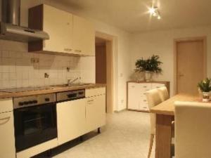 a kitchen with a sink and a stove top oven at Apartment Mortelgrund by Interhome in Sayda