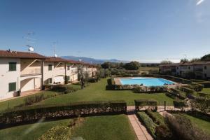 an external view of a villa with a garden and a swimming pool at Blu Garda View in Polpenazze del Garda