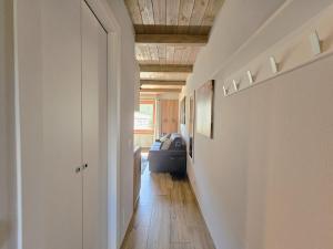 a hallway leading to a living room with a couch at Moda Apartments 69 in Sestriere