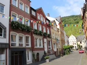 a street in a town with flags and buildings at Apartment Haus Budinger by Interhome in Alf