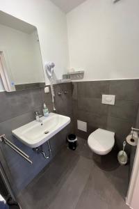 a bathroom with a sink and a toilet and a mirror at Apartment Haus Budinger by Interhome in Alf