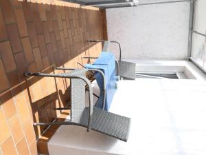 a bench with a blue shirt on it on a balcony at Apartment Haus Budinger by Interhome in Alf +3 photos