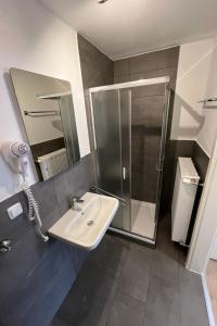 a bathroom with a sink and a shower at Apartment Haus Budinger by Interhome in Alf