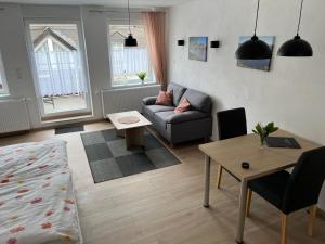 a living room with a couch and a table at Apartment Haus Budinger by Interhome in Alf