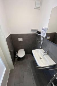 a bathroom with a toilet and a sink at Apartment Haus Budinger by Interhome in Alf +6 photos