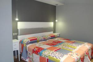 Postel nebo postele na pokoji v ubytování Hostal El Recanto