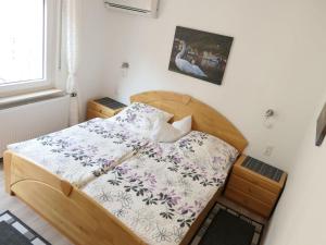 a small bedroom with a wooden bed in a room at Apartment Haus Budinger by Interhome in Alf