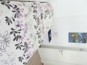a kitchen with a purple and white wallpaper at Apartment Haus Budinger by Interhome in Alf