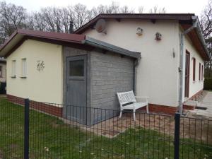 a shed with a bench in front of a house at Holiday Home Klosterwald by Interhome in Dargun