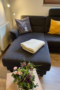 a living room with a couch with a pillow and a table at Apartment FeWo Siebert by Interhome in Bad Brambach