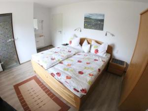 a bedroom with a bed with a floral bedspread at Apartment Haus Budinger by Interhome in Alf
