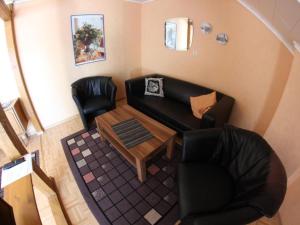a living room with a couch and a table at Apartment Haus Budinger by Interhome in Alf