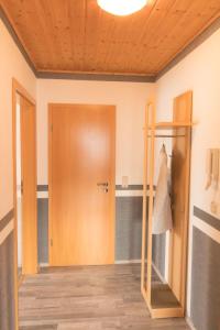 a room with a wooden door and a mirror at Apartment Fewo Dirks 2 by Interhome in Hemfurth-Edersee +15 photos