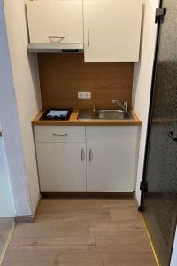 a small kitchen with a sink and a counter at Apartment Haus Budinger by Interhome in Alf