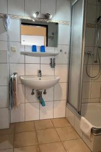 a bathroom with a sink and a shower at Apartment Haus Budinger by Interhome in Alf