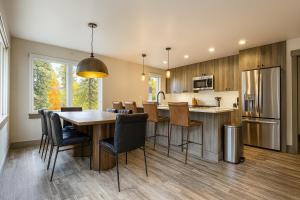 a kitchen with a table and chairs in a kitchen at NEW 2BR w/ Ski Views, Bunk Room & Resort Access in Durango Mountain Resort
