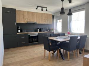a kitchen and dining room with a table and chairs at Apartment Haus Budinger by Interhome in Alf