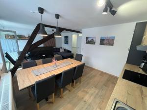 a dining room and living room with a table and chairs at Apartment Haus Budinger by Interhome in Alf