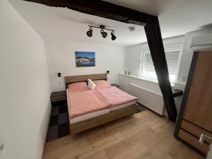 a bedroom with a pink bed and a window at Apartment Haus Budinger by Interhome in Alf +16 photos