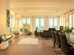 a living room with a couch and chairs and windows at Apartment Meerblick&SPA by Interhome in Ostseebad Sellin