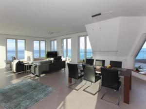 a living room with a couch and a table and chairs at Apartment Meerblick&SPA by Interhome in Ostseebad Sellin