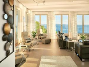 a living room with couches and chairs and windows at Apartment Meerblick&SPA by Interhome in Ostseebad Sellin +51 photos