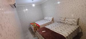 a small room with a bed and a small bed at "Taberna dos Castilho" in Bertioga