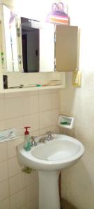a bathroom with a white sink and a mirror at Las Gemelas in Rosario