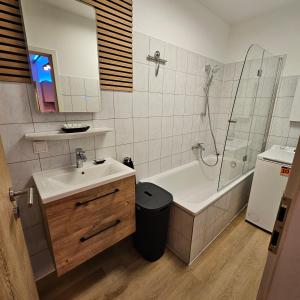 a bathroom with a sink and a tub and a shower at Sweet Apartment Düsseldorf City B27 in Düsseldorf