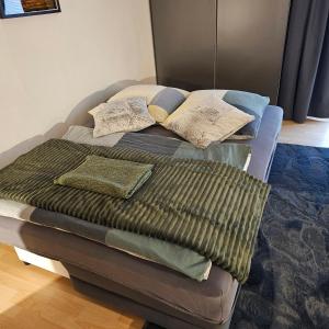 a bed with pillows on it in a room at Sweet Apartment Düsseldorf City B27 in Düsseldorf