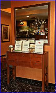 a wooden dresser in a restaurant with signs on it at Hotel Meeting in Ciampino
