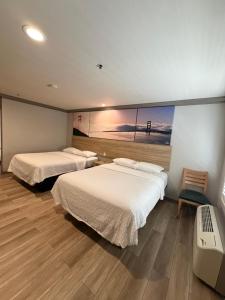 Giường trong phòng chung tại Days Inn by Wyndham San Francisco S/Oyster Point Airport +14 ảnh