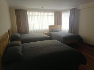 En eller flere senge i et værelse på Casa ENLACE