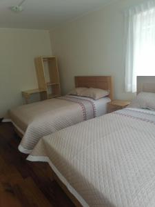 En eller flere senge i et værelse på Casa ENLACE