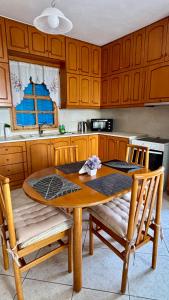 una cucina con un tavolo di legno e due sedie di Dina's Beach House a Karpathos Altre 28 foto