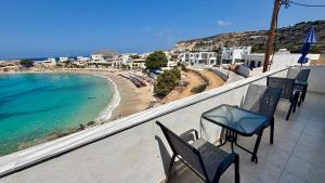 a balcony with chairs and a view of a beach at Dina's Beach House in Karpathos