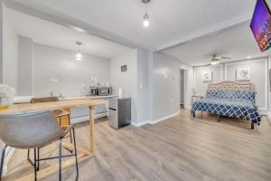 a room with a bed and a desk and a kitchen at Cozy Private Suite in Worcester