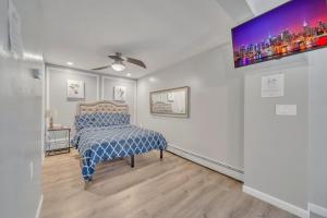a bedroom with a bed with a blue and white comforter at Cozy Private Suite in Worcester