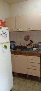 a kitchen with a white refrigerator and a sink at Las Gemelas in Rosario +12 photos