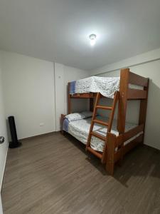 a bedroom with a bunk bed and a ladder at Moderno Mn Depa en San Bartolo in San Bartolo