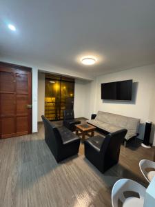 a living room with a couch and a table and chairs at Moderno Mn Depa en San Bartolo in San Bartolo